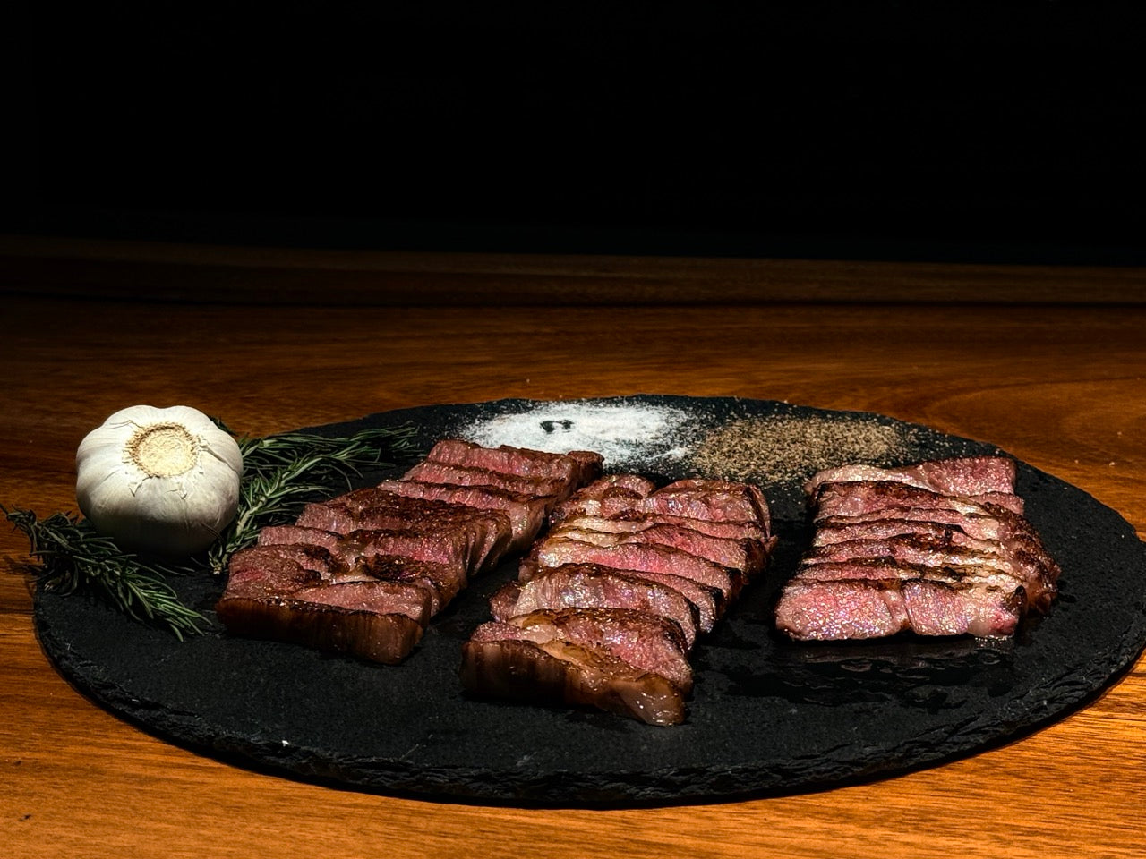 Premium Wagyu being seared with a blowtorch on a wire grill